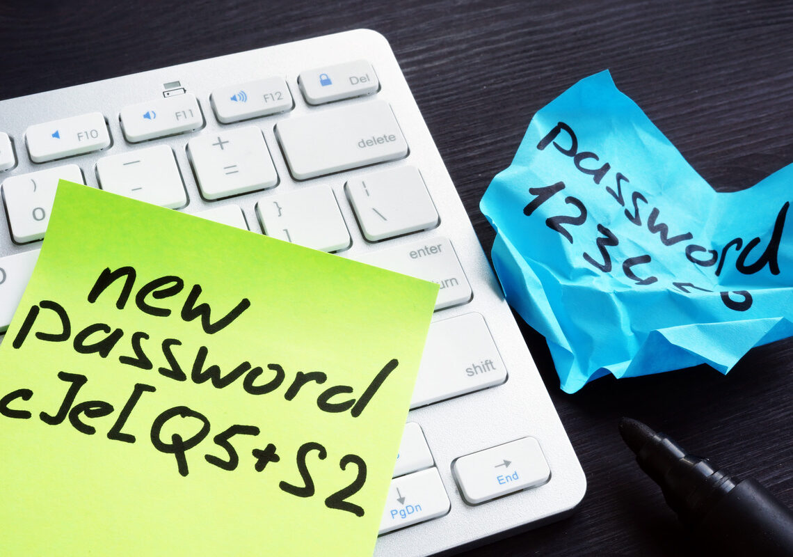 A green sticky note says "new password" with a combination of letters and symbols. A blue sticky note reads "password 123456."