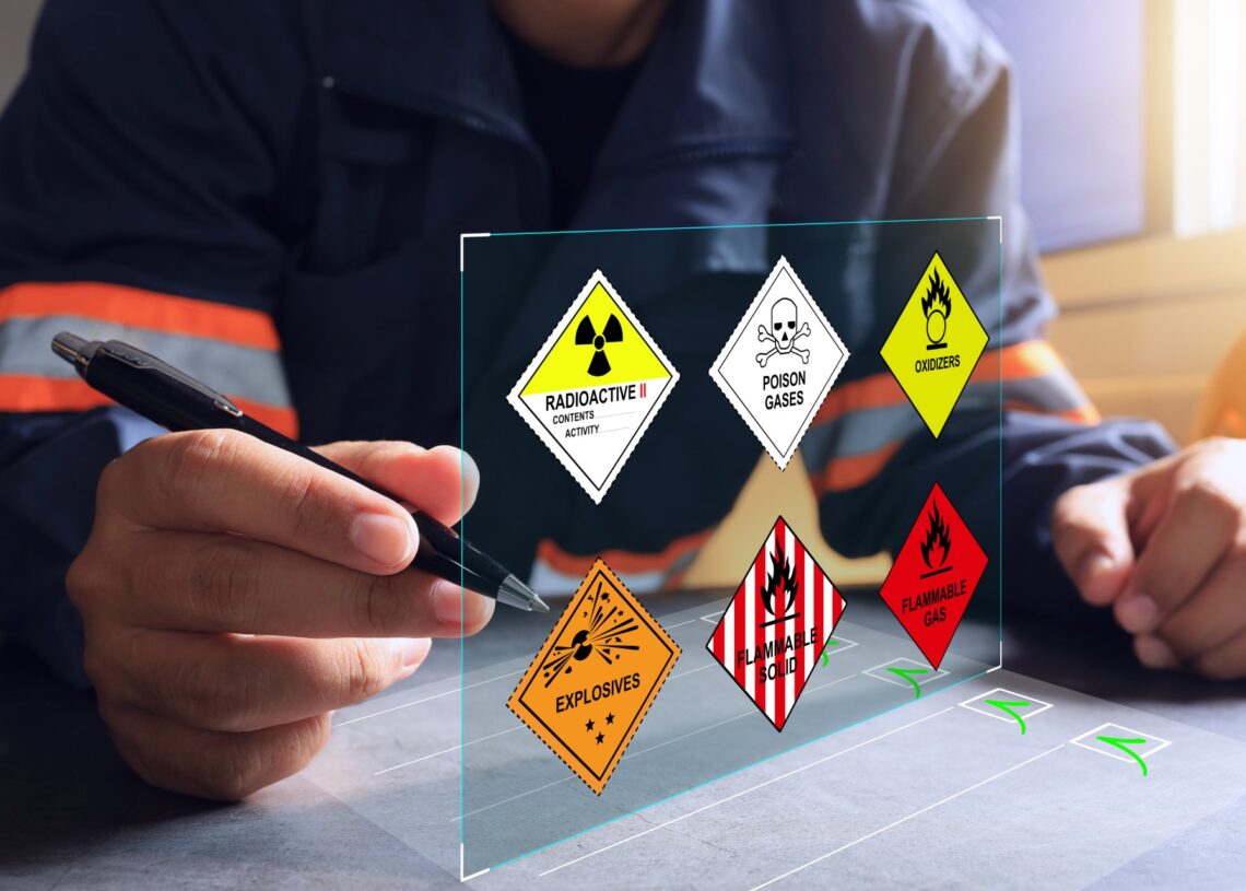 A safety inspector checking off a virtual list of hazmat dangers, such as POISON GASES and EXPLOSIVES.