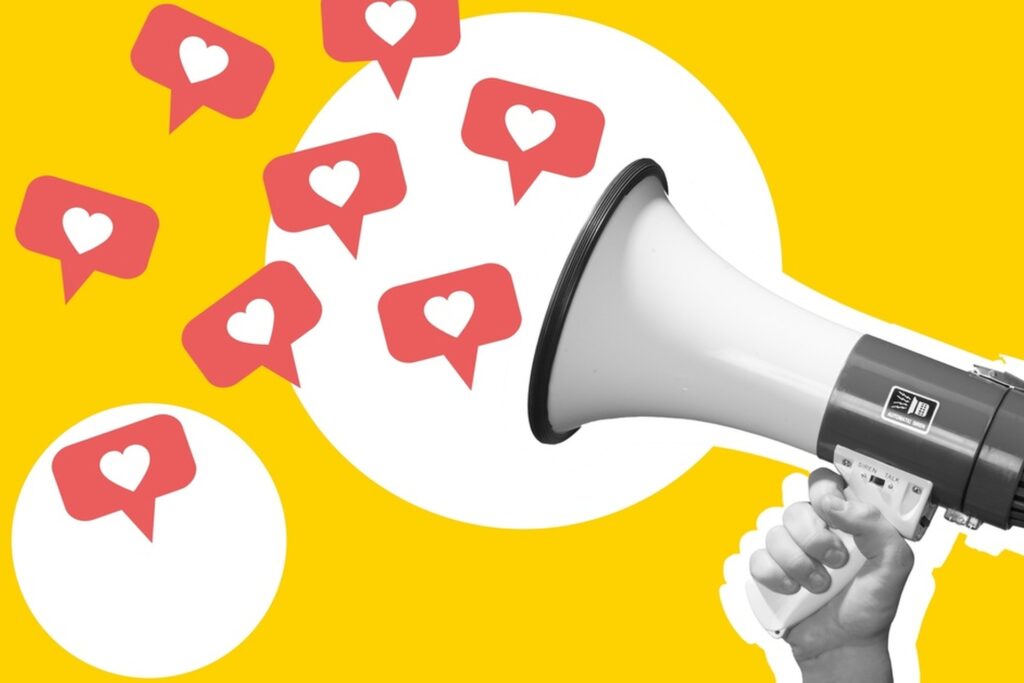 A hand holding a megaphone in black-and-white, with speech bubbles with hearts in the middle coming out of the megaphone.