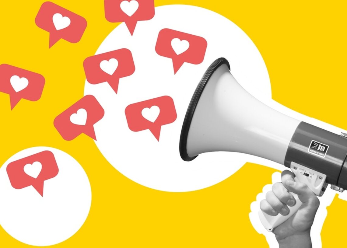 A hand holding a megaphone in black-and-white, with speech bubbles with hearts in the middle coming out of the megaphone.