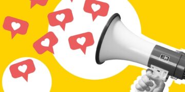 A hand holding a megaphone in black-and-white, with speech bubbles with hearts in the middle coming out of the megaphone.