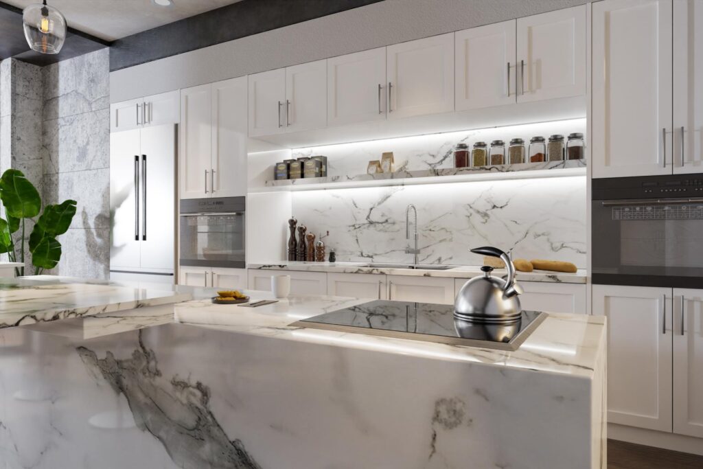 A kitchen with white cabinets and an island in the center of the room. The island has quartz waterfall countertops.