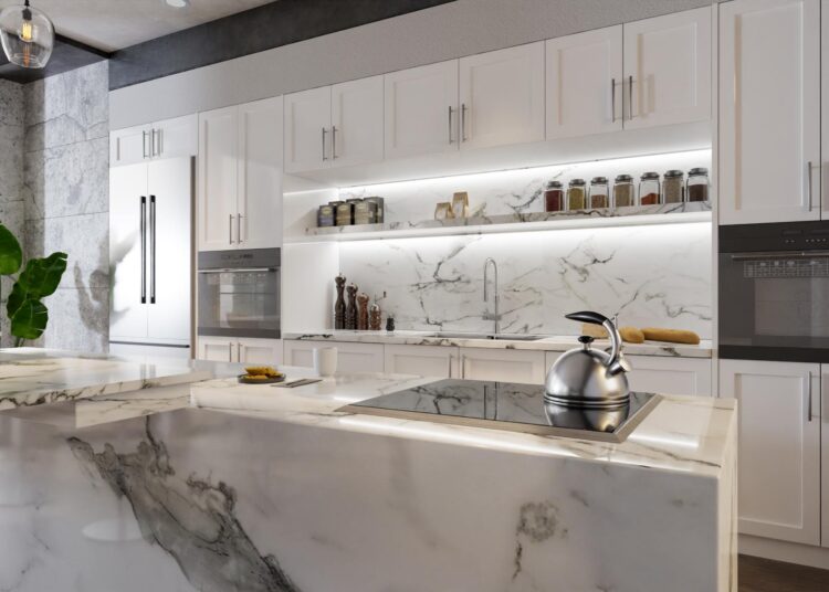 A kitchen with white cabinets and an island in the center of the room. The island has quartz waterfall countertops.