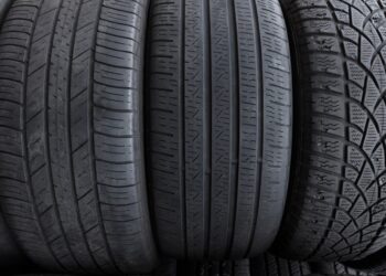A lineup of three tires, upright, facing the viewer. Each tire is a different size with a distinct tread pattern.