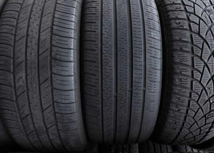 A lineup of three tires, upright, facing the viewer. Each tire is a different size with a distinct tread pattern.
