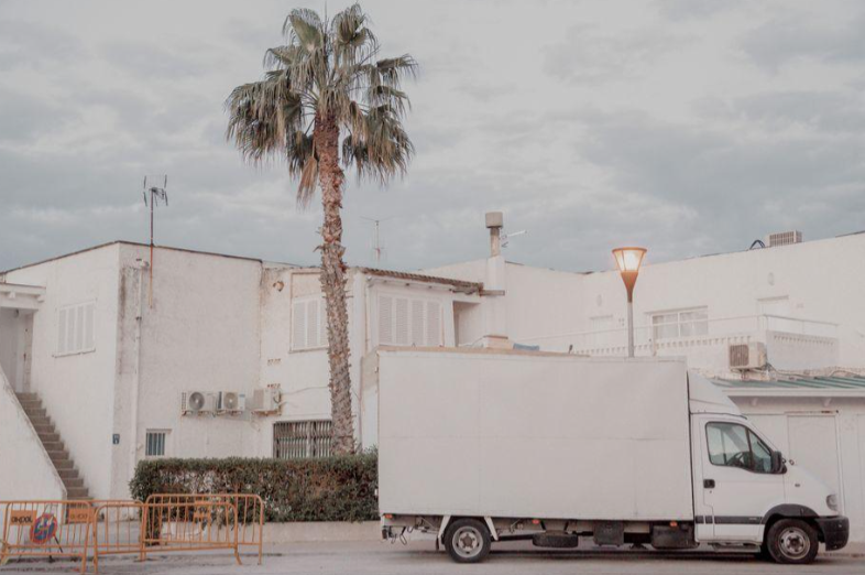 A moving truck parked outside a house