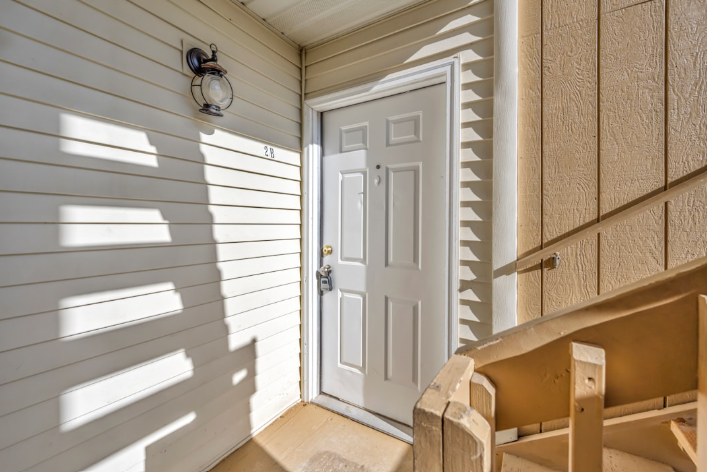 A child's backpack and shoes waiting by a front door